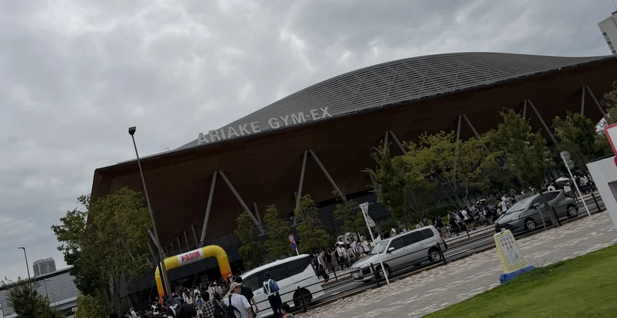 トミカ博2026の会場、有明GYM-EXの外観。建物名の下にトミカ博の風船アーチが設置され、来場者の列ができている